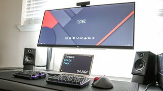 The Google Pixel Tablet underneath an ultrawide monitor on a desk