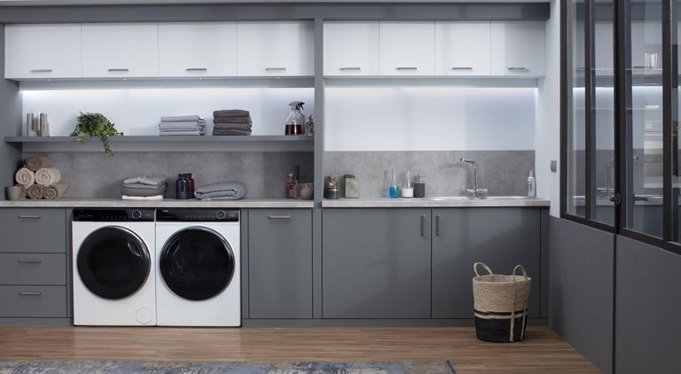 the Haier washer dryer, one of the best washing machine options, in a modern grey and white kitchen
