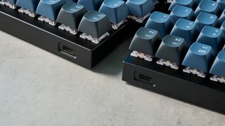 A carbon black Keychron Q11 split ergonomic keyboard