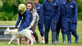 Kate Middleton plays with a lamb at a farm