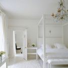 room with white wall canopy and chandelier