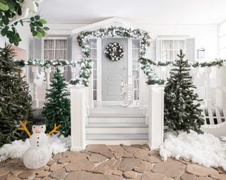 festive front porch with faux snow and snowman