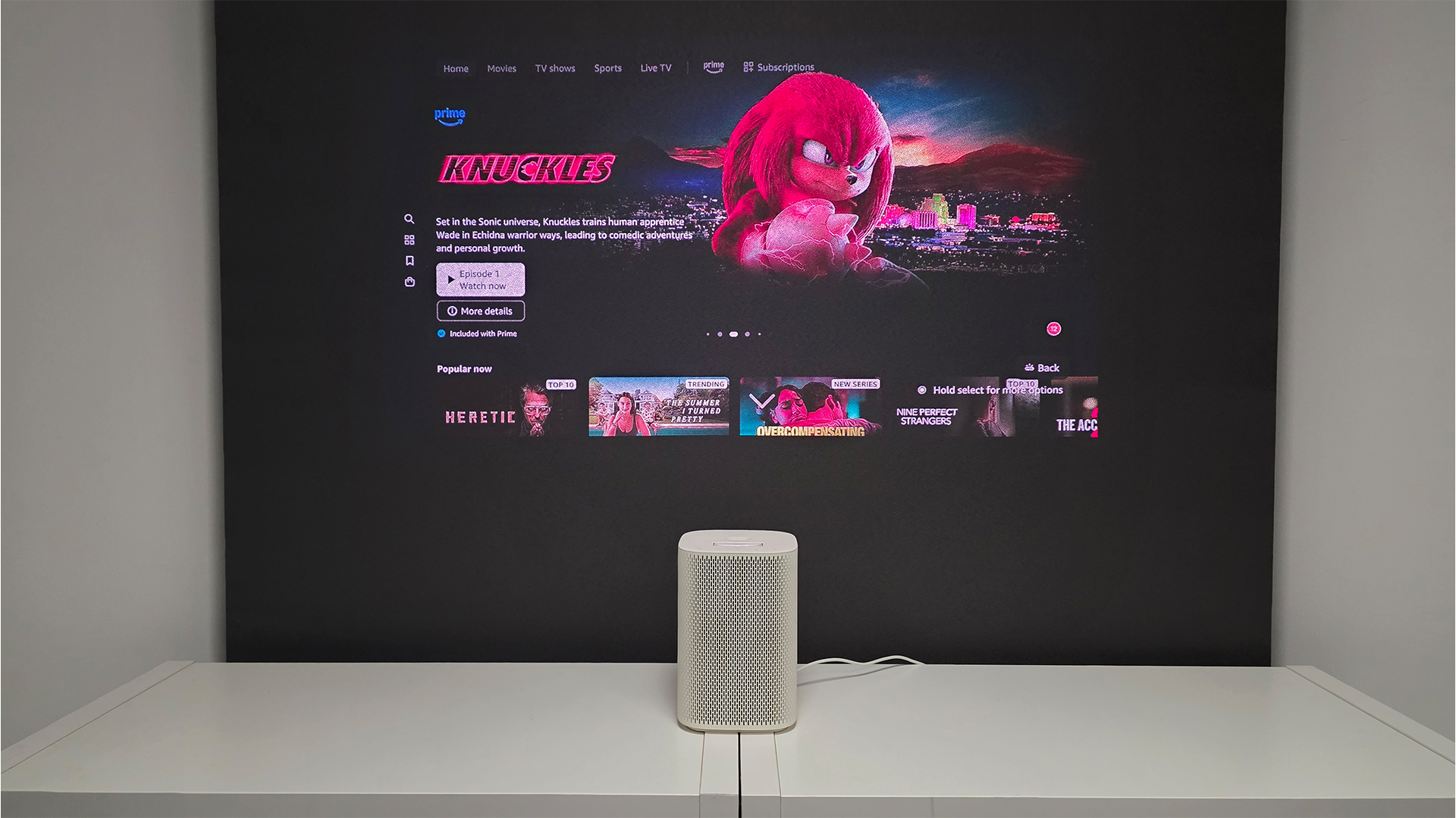 Samsung The Premiere 5 ultra short throw projector in front of screen showing Knuckles