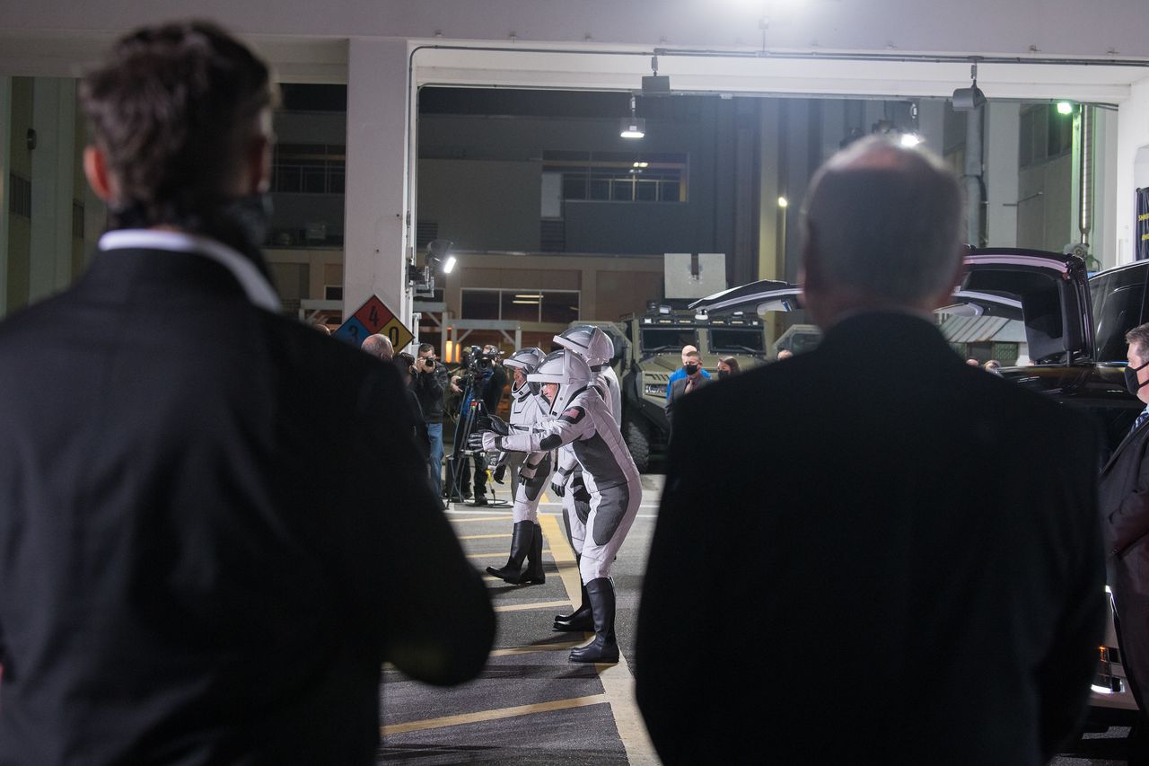 Acting NASA Administrator Steve Jurczyk (back, center) and SpaceX founder Elon Musk (right) watch the crew-2 astronauts.
