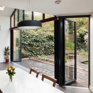 black aluminium bifold doors with entry door