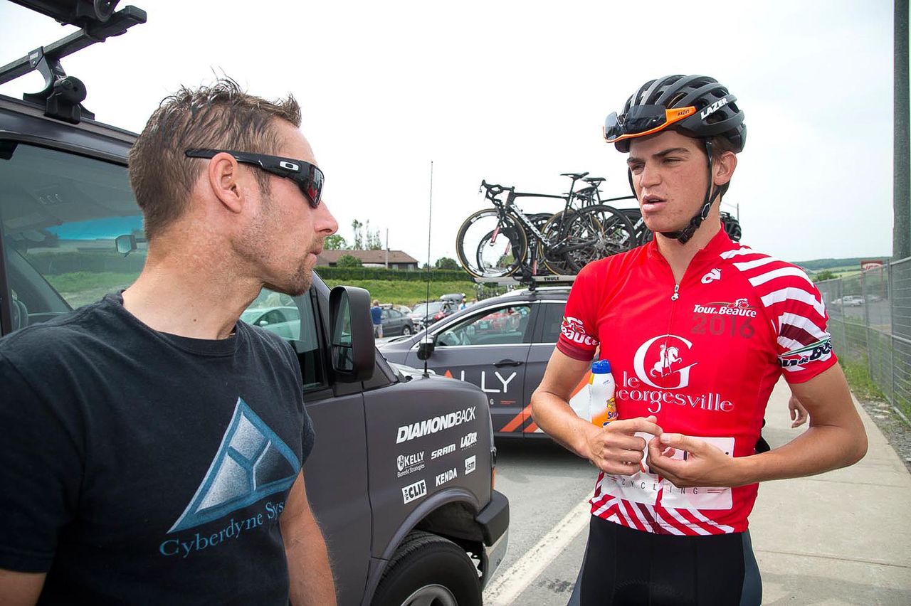 Sepp Kuss, in the red climber's jersey at Tour de Beauce, talks with Rally Cycling director Eric Wohlberg