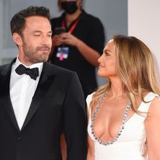Ben Affleck and Jennifer Lopez look lovingly at one another as they walk the red carpet.