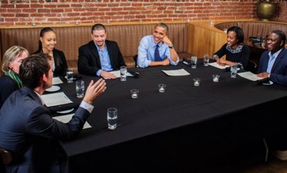 President Obama talks with the winners of the Dinner with Barack fundraising contest on Oct. 12, 2012.