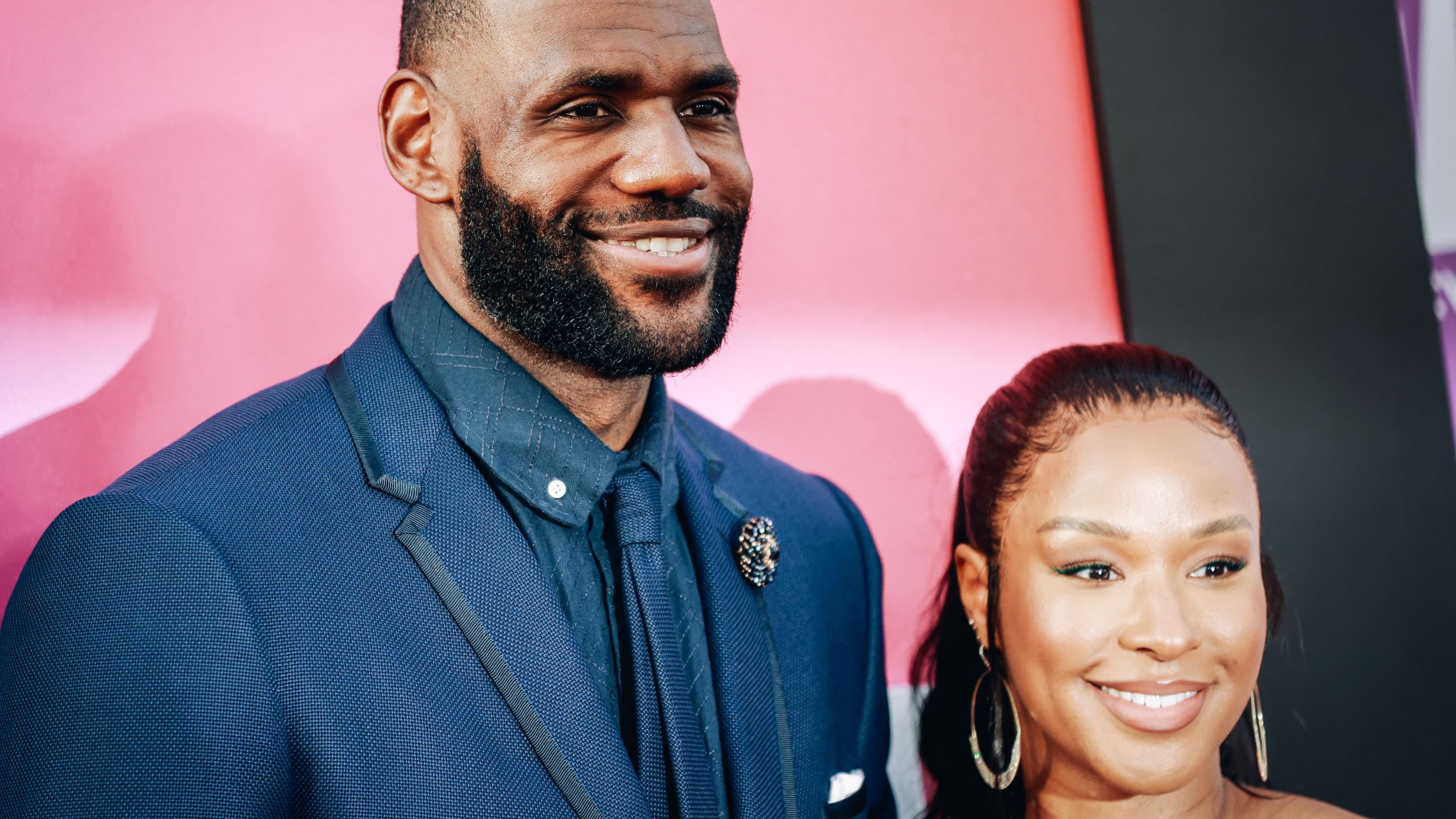 lebron and savannah james on a red background