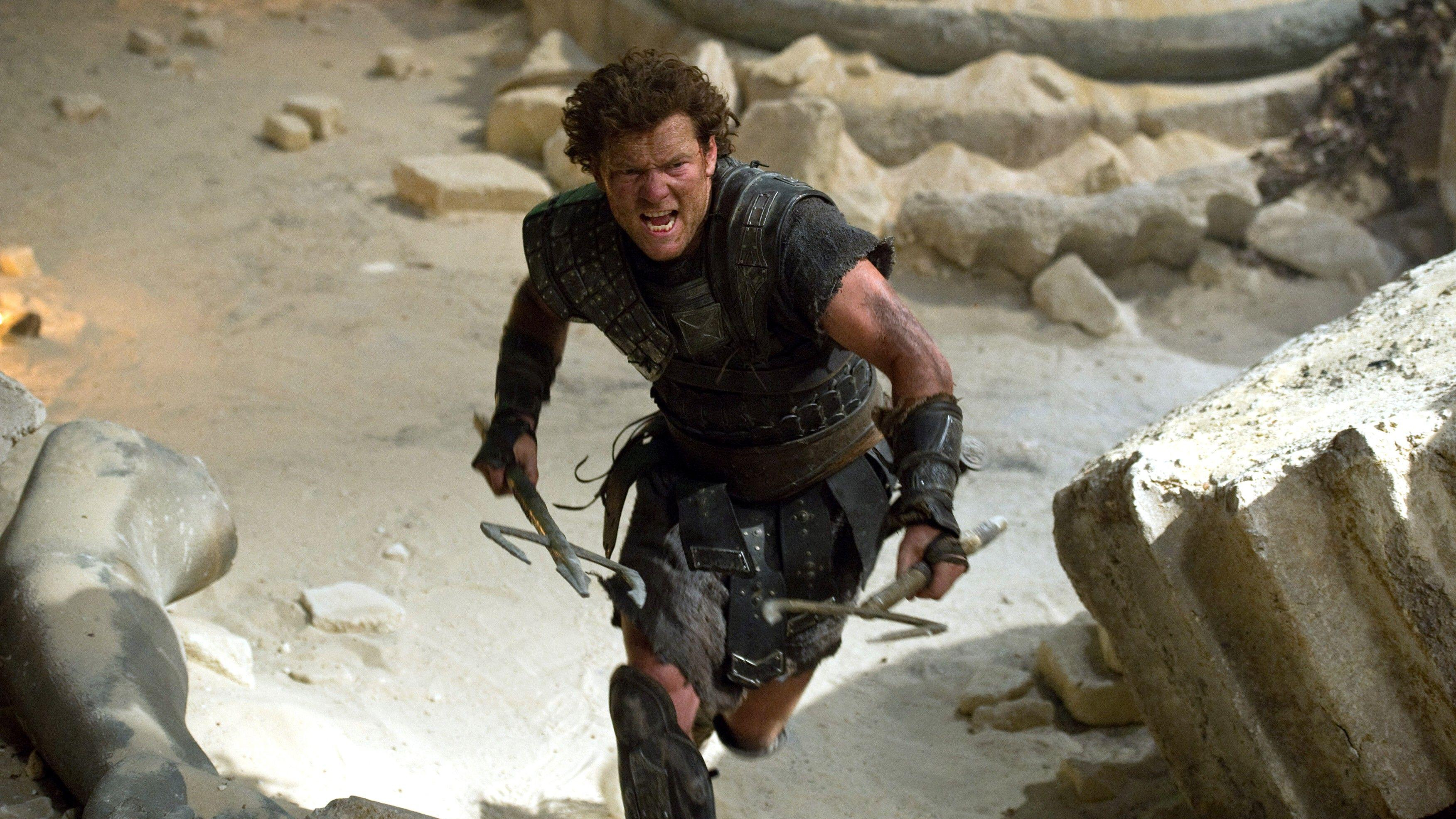 Perseus (Sam Worthington) charges with two spears in hand in a scene from "Wrath of the Titans"