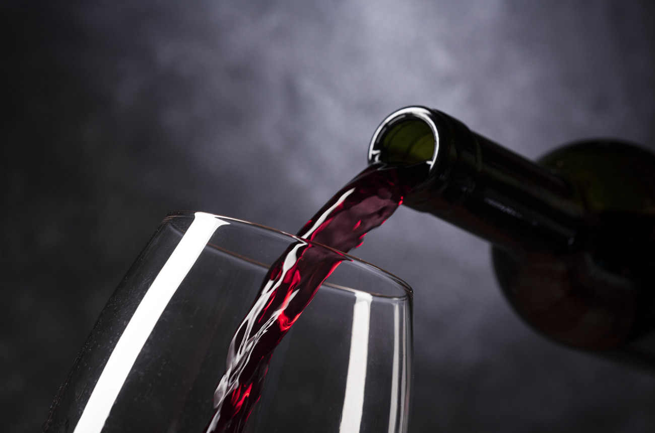 red-wine-pouring-from-bottle-into-glass