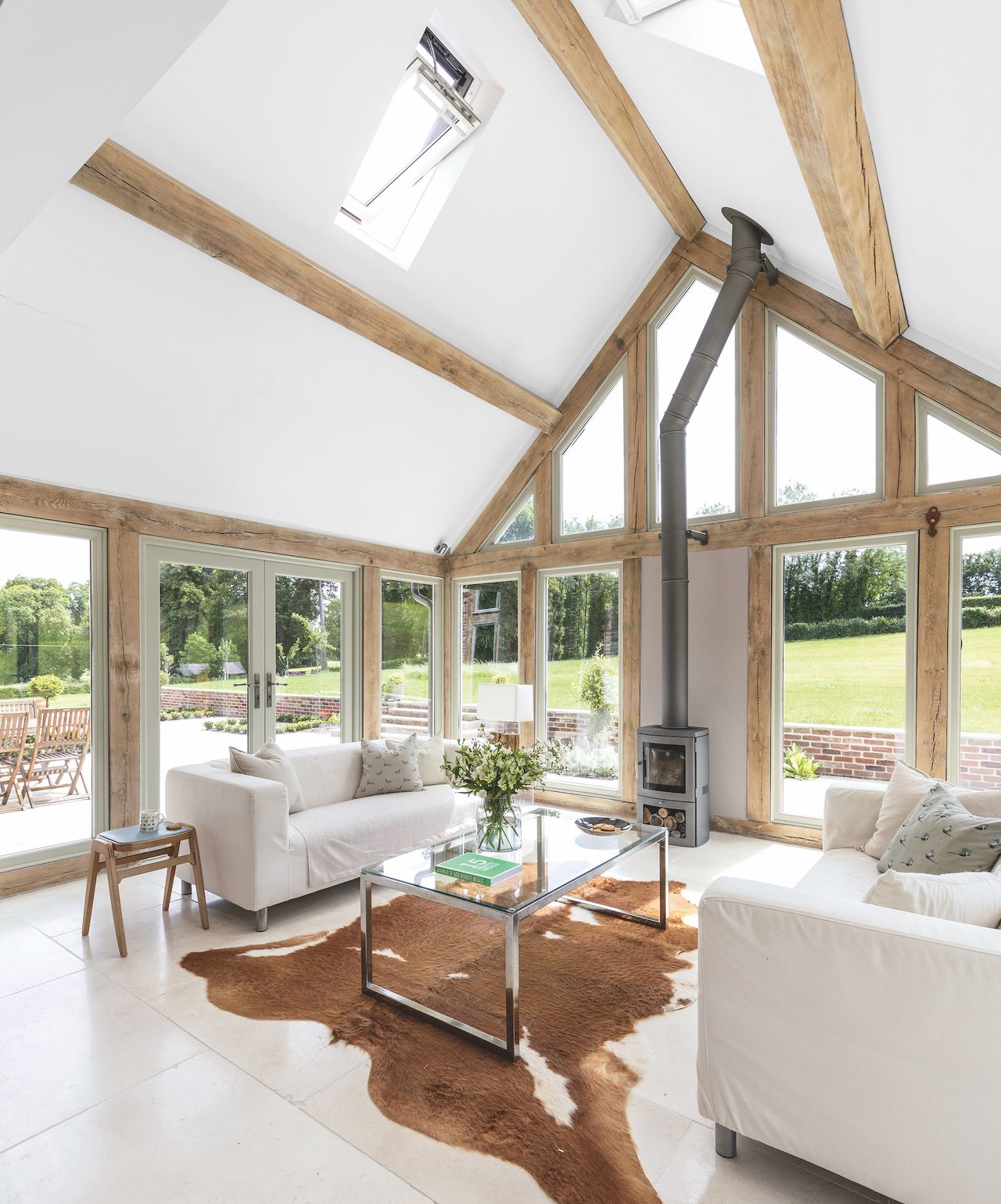 oak frame sunroom with vaulted ceiling and stove