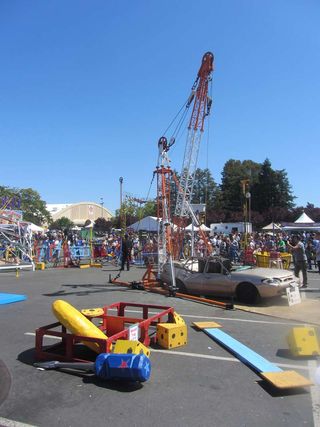 Makers share their creations, including a giant mousetrap (background).