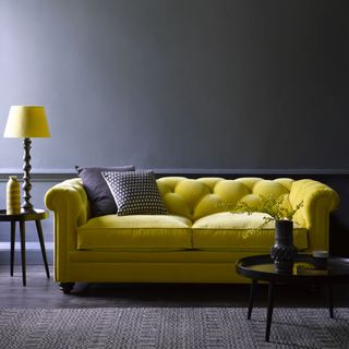 grey living room ideas, grey living room with bright yellow sofa and lamp
