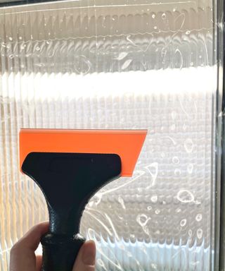 Using a squeegee to push air bubbles out