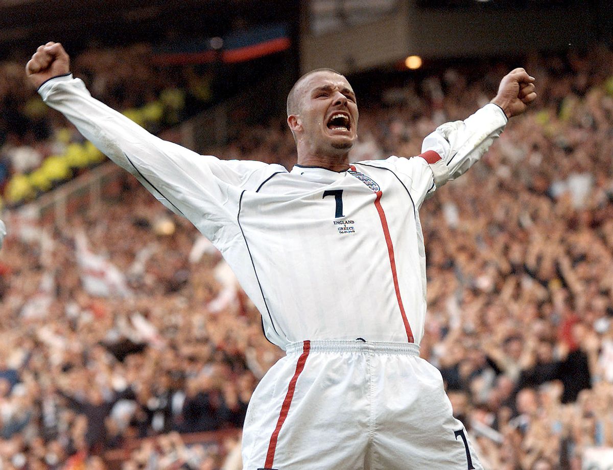 David Beckham celebrates after scoring his famous free-kick for England against Greece in the 2002 World Cup qualifying match at Old Trafford in Manchester, England, October 2001.