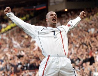 David Beckham celebrates after scoring his famous free-kick for England against Greece in the 2002 World Cup qualifying match at Old Trafford in Manchester, England, October 2001.