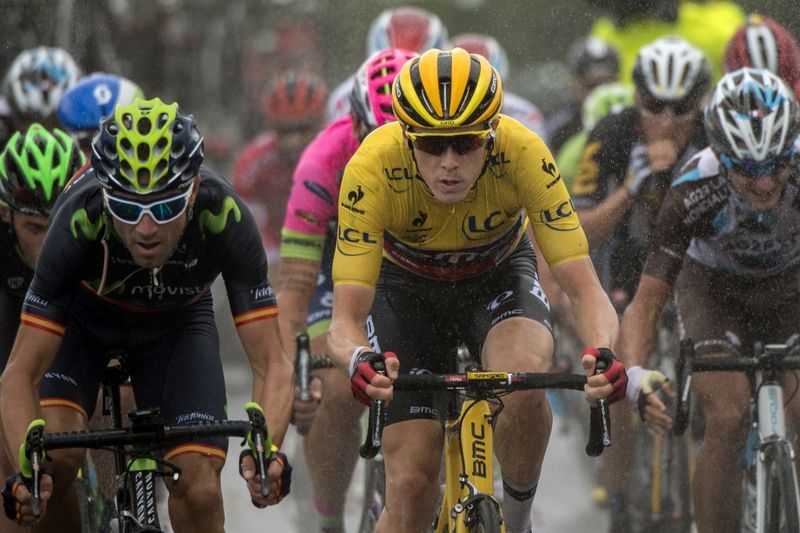 Rohan Dennis in yellow alongside Alejandro Valverde on the left