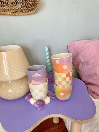 Purple squiggly side table with cups stacked