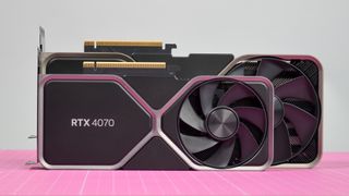 An Nvidia GeForce RTX 4070 graphics card sitting in front of a much larger Nvidia RTX 4080 graphics card