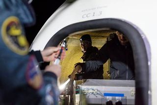 Blue Origin crew works on door to crew capsule