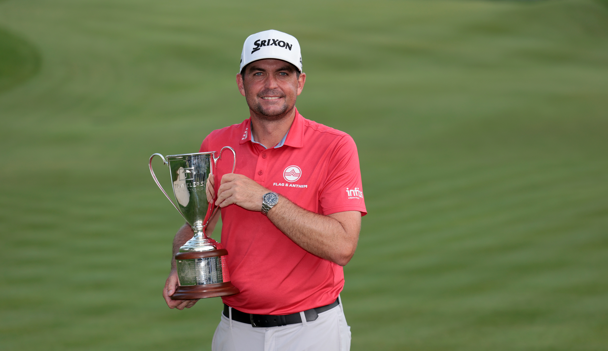 Keegan Bradley holds the Travelers Championship trophy