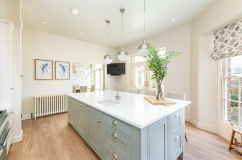 A kitchen island with overhead lighting