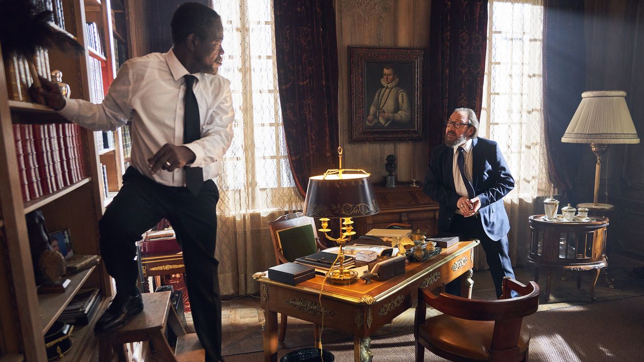 Fargass Assanded as Babakar Diop and Herve Pierre as Hubert Pellegrini in the Netflix series "Lupin."