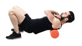 Man using a foam roller on his back