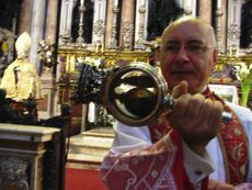 During the "blood miracle" ceremonies (this photo from 2013), the archbishop of Naples shakes a vial of San Gennaro's "blood," a solid mass, to see if it turns into liquid. 