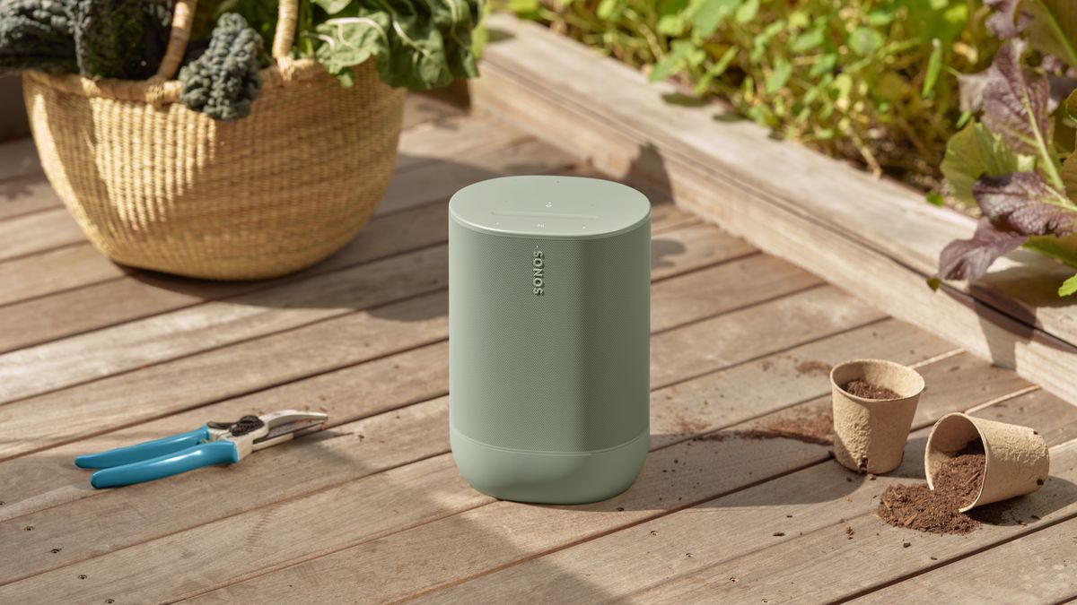 The Sonos Move 2 in Olive sitting in a garden.