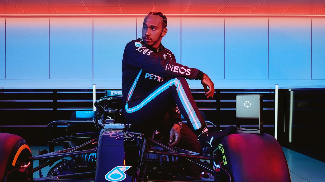 Lewis Hamilton posed next to his racing car, with INEOS Hand Sanitizer dispenser