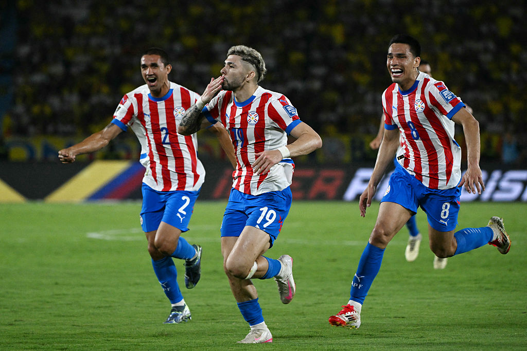 Paraguay World Cup 2026 squad: Paraguay&#039;s forward #19 Julio Enciso (C) celebrates next to teammates defender #02 Gustavo Velazquez and midfielder #08 Diego Gomez after scoring his team second goal during the 2026 FIFA World Cup South American qualifiers football match between Colombia and Paraguay at the Metropolitano Roberto Melendez stadium in Barranquilla, Colombia, on March 25, 2025.