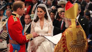 Prince William and Kate Middleton with a priest getting married