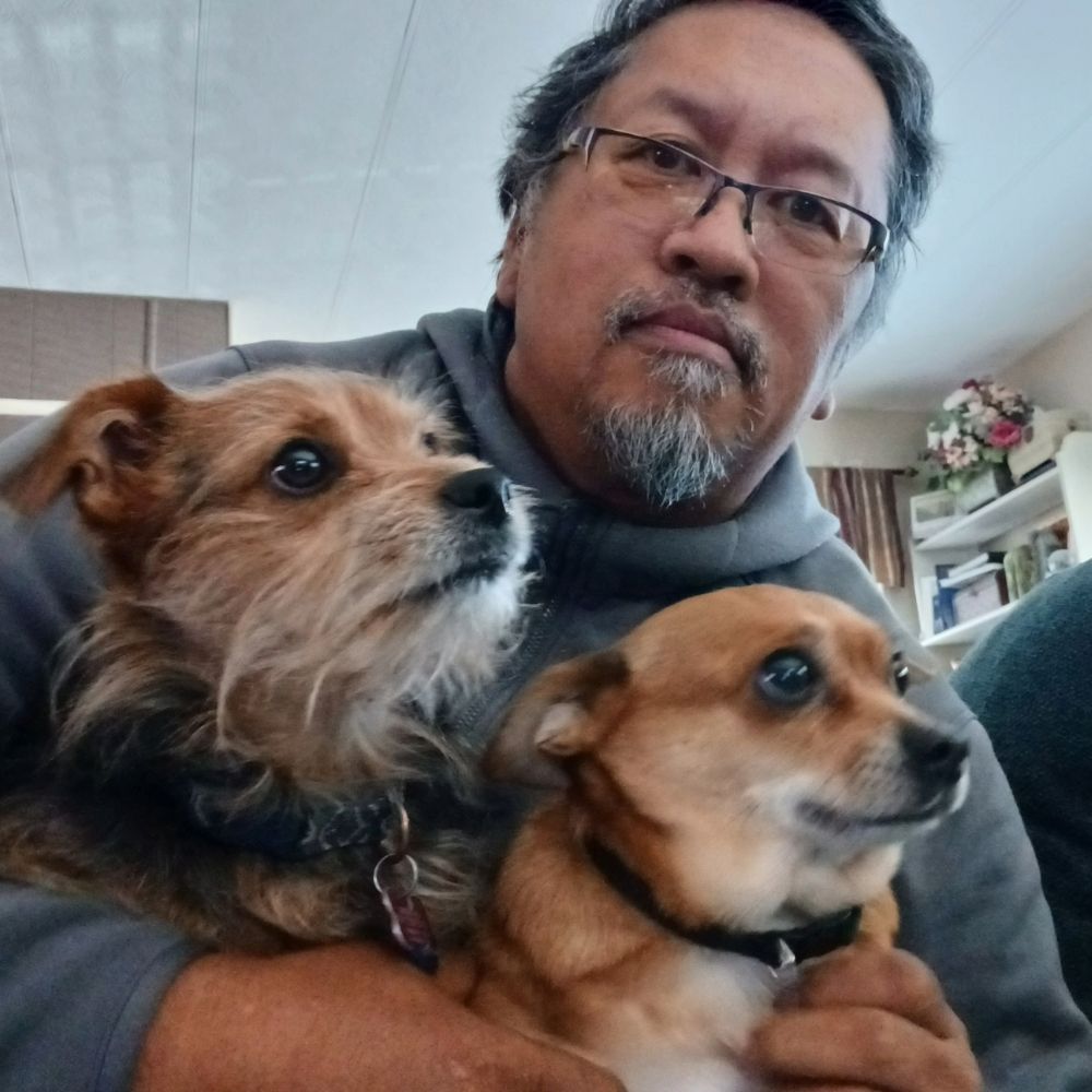 Michael holding his two dogs