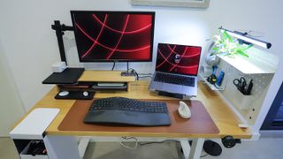 A monitor on an arm, a laptop and other items on the fully assembled EverDesk Max