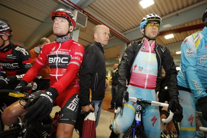The start of the Giro d'Italia's 12th stage was delayed due to a bus blocking the road, so riders such as points leader Cadel Evans (BMC) and maglia rosa holder Vincenzo Nibali (Astana) sought shelter out of the rain.