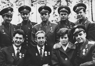 Photo of the cosmonauts of the Russian spacecraft Voskhod 1 being given a welcome reception by their fellow space pioneers at Zvyozdny, 30th October 1964. From left to right, (back row) Valery Bykovsky, Gherman Titov (1935 - 2000), Yuri Gagarin (1934 - 1968), Andriyan Nikolayev (1929 - 2004) and Pavel Popovich (1930 - 2009); (front row) Boris Yegorov (1937 - 1994), Konstantin Petrovich Feoktistov (1926 - 2009), Valentina Tereshkova and Vladimir Mikhaylovich Komarov (1927 - 1967). The three men in the front row are the Voskhod 1 cosmonauts.