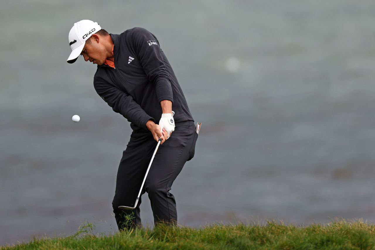 Collin Morikawa hits a chip shot