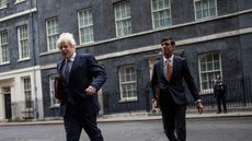 Boris Johnson and Rishi Sunak leave Downing Street to attend a meeting of the cabinet.