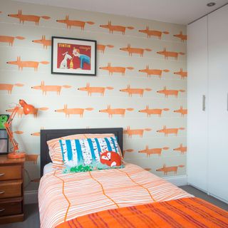 kids bedroom with orange patterned feature wall