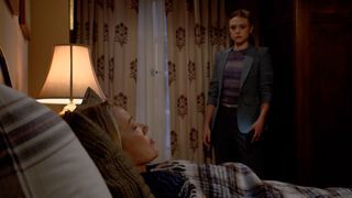 Melody Thomas Scott as Nikki laying in bed and Hayley Erin as Claire standing over her in The Young and the Restless