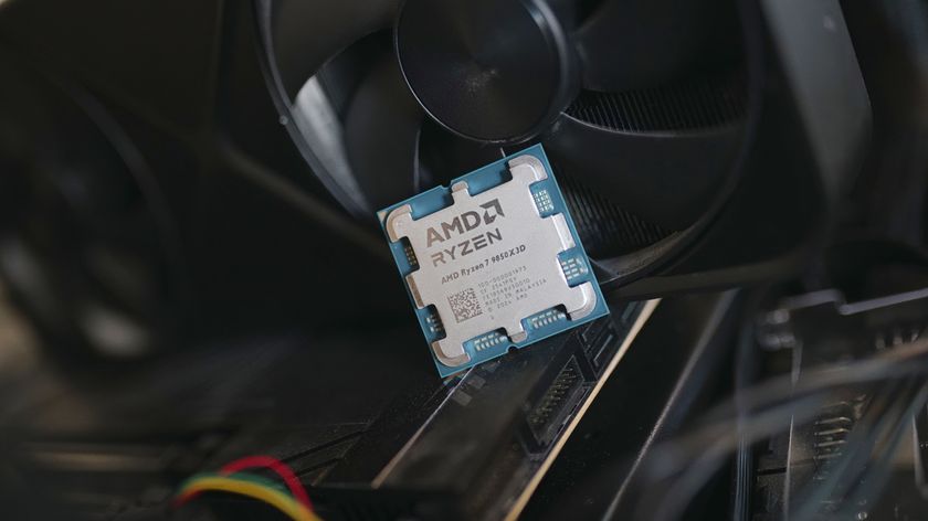 The Ryzen 7 9850X3D CPU leaning against a graphics card.