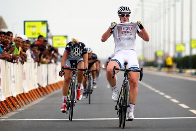 Stage 3 winner Kirsten Wild thanks her team's sponsors as she crosses the finish line.