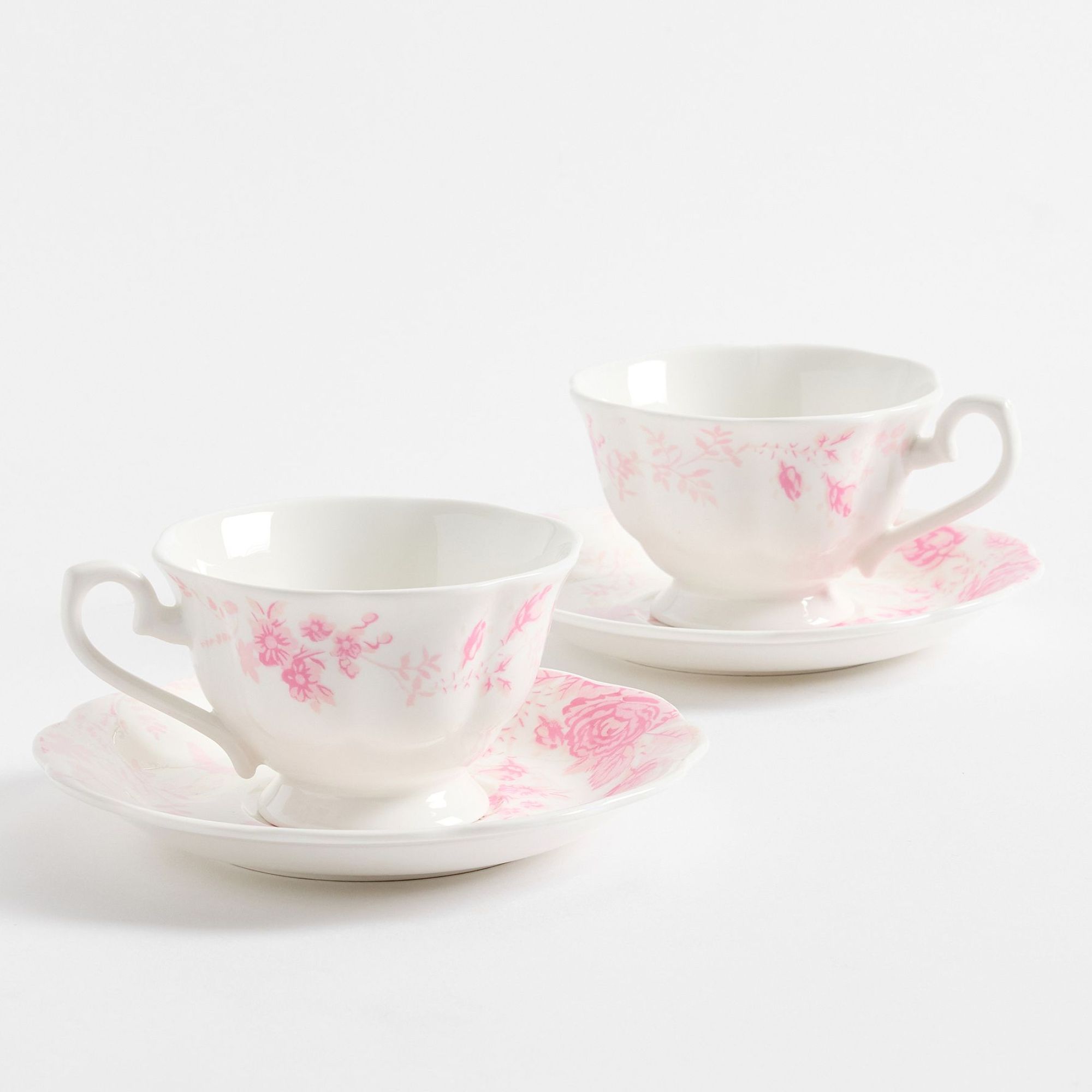 White and pink floral tea cups with saucers