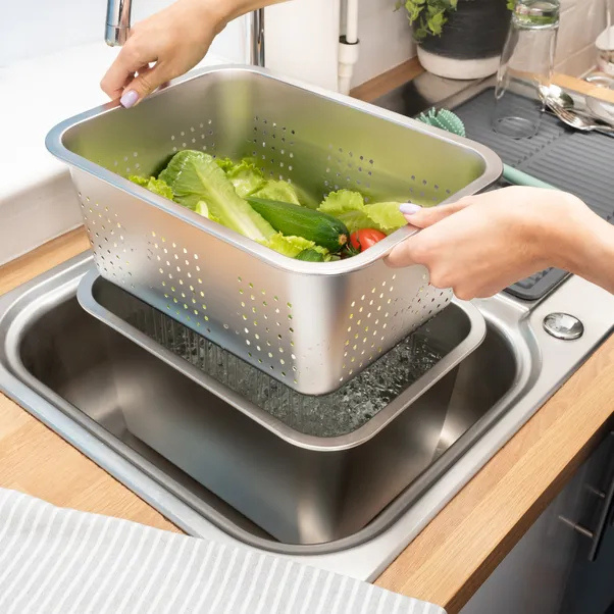 Dunelm steel washing up bowl with strainer in sink.