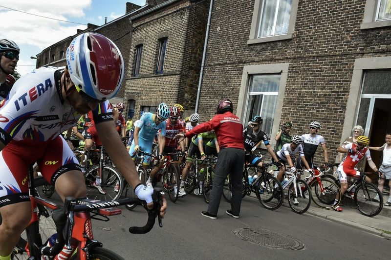 A race official stop the peloton