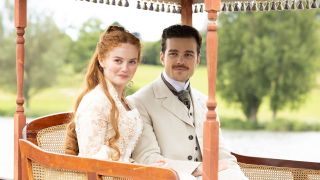 A radiant Irene (Millie Gibson) and dapper chap Soames (Joshua Orpin) take a cosy country carriage ride in Channel 5 drama The Forsytes.
