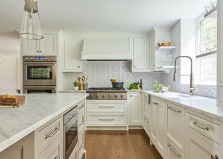 tonal white kitchen with warm wood flooring