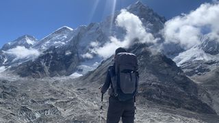 Julia Clarke wearing an Osprey Tempest pack looks at the mountains on the trek to Everest Base Camp